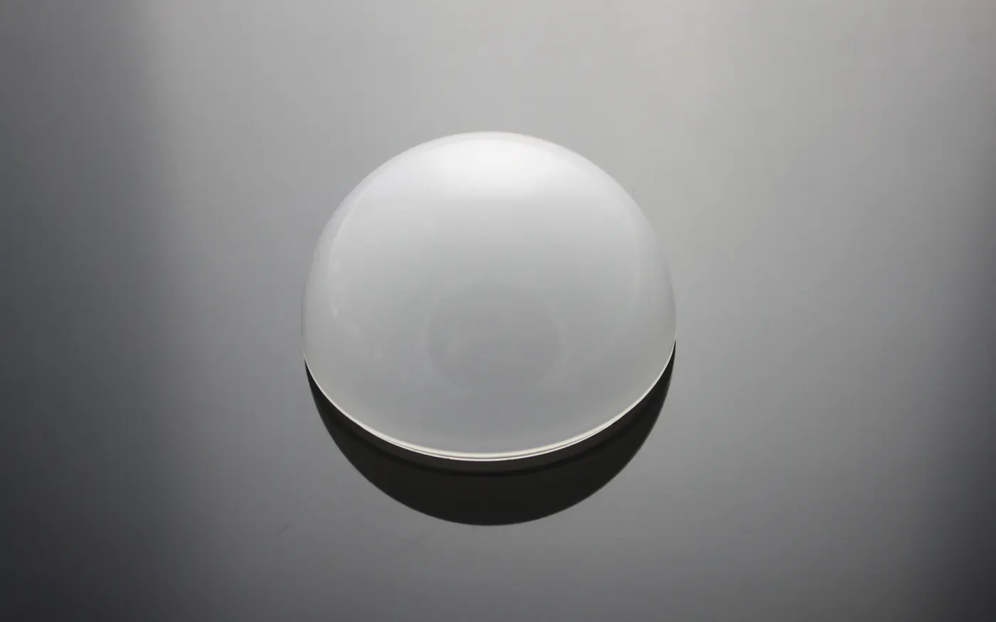 Opal acrylic ball on a reflective dark surface