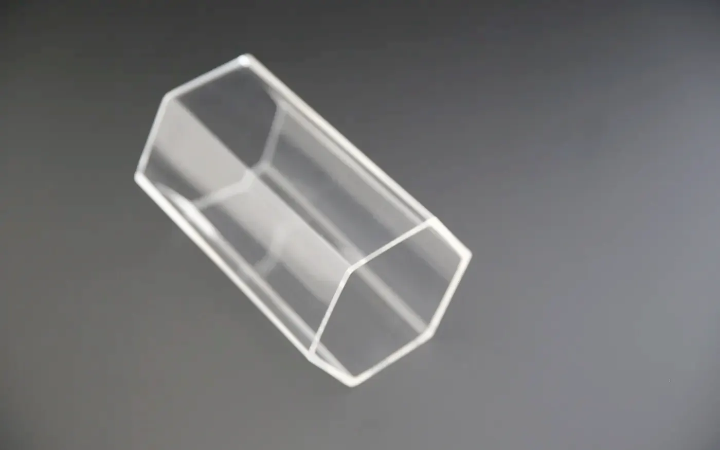 Clear extruded acrylic hexagonal tube seen from the end