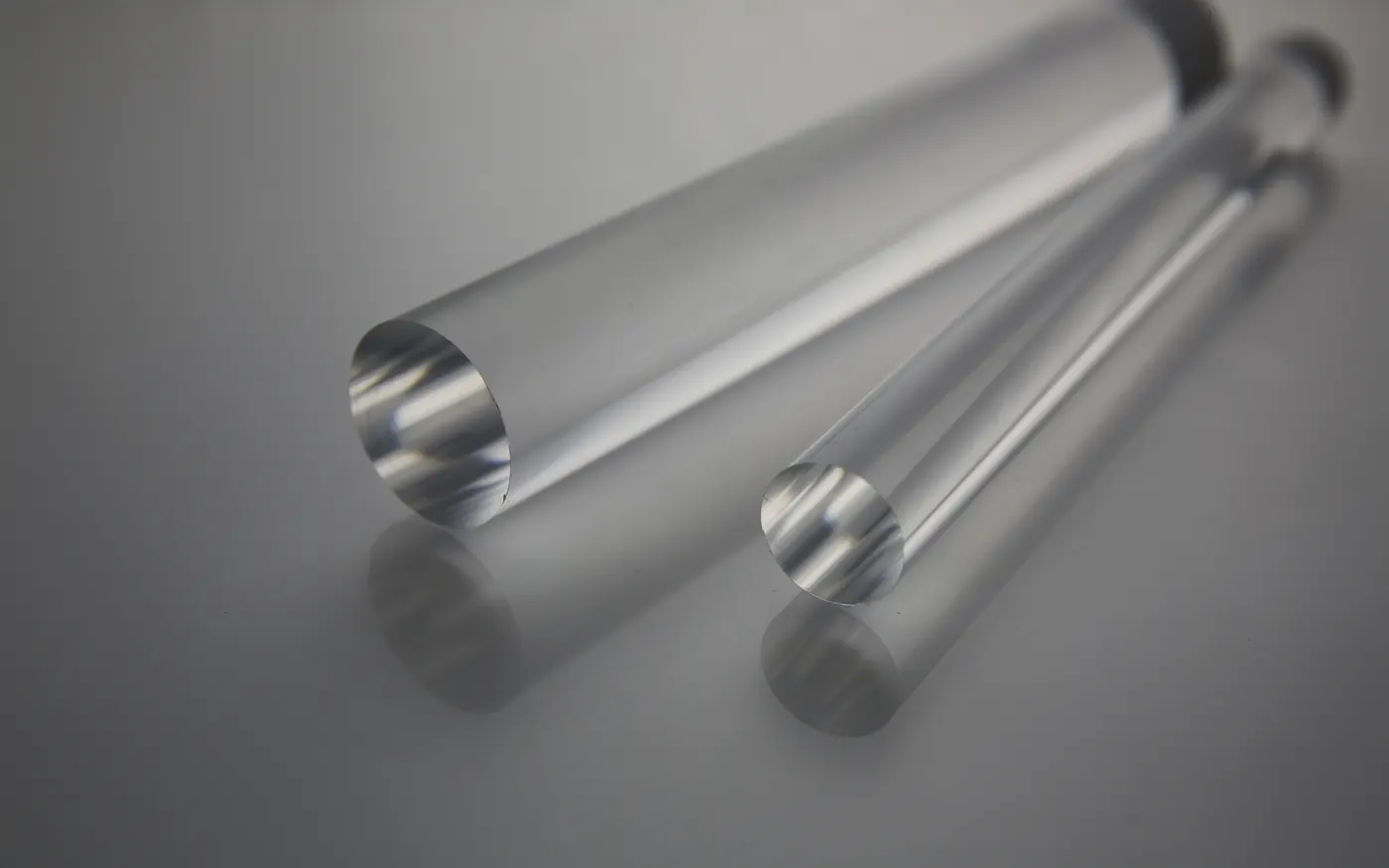 Two clear solid extruded acrylic round rods with cut ends