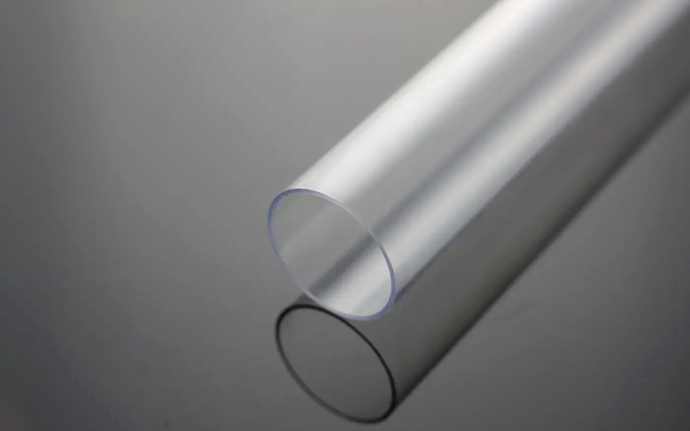 Extruded round tube; the same die sections run in both PMMA and polycarbonate