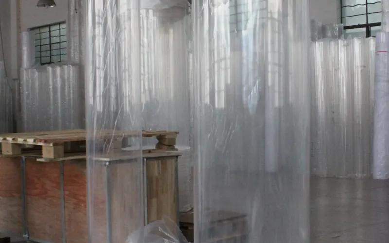 Cast acrylic cylinders wrapped and stored upright