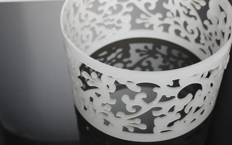 Frosted acrylic cylinder with a cut decorative pattern