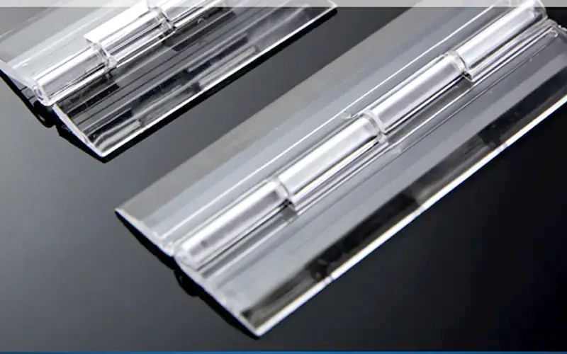 Clear acrylic piano-style hinges lying flat